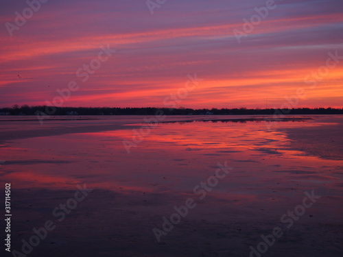 Beautiful Winter Sunset on Ice Covered Lake