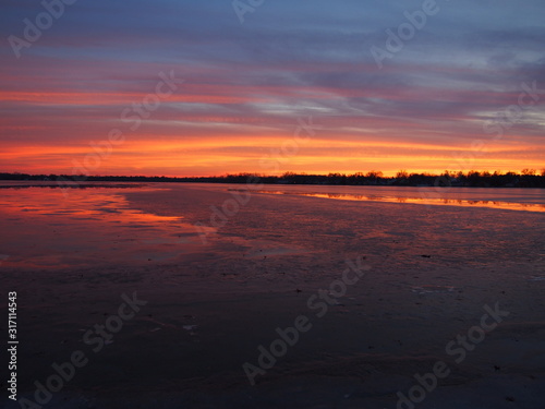 Beautiful Winter Sunset on Ice Covered Lake