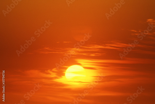 Fototapeta Naklejka Na Ścianę i Meble -  Sun Setting Through Clouds