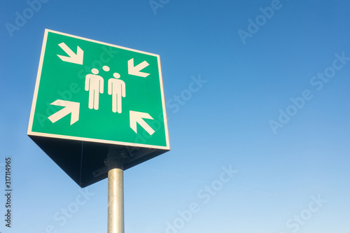 Wallpaper Mural outdoor sign in Germany for a meeting point isolated against the sky. Torontodigital.ca