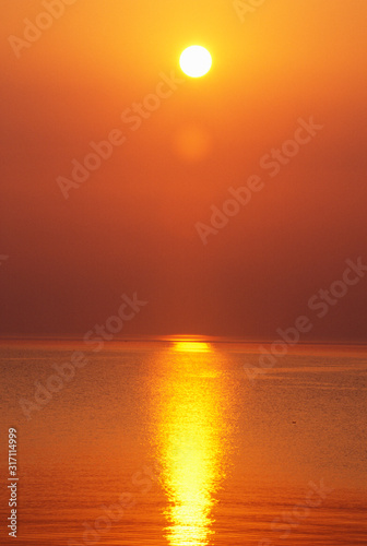 Fototapeta Naklejka Na Ścianę i Meble -  Sun Setting Over The Ocean