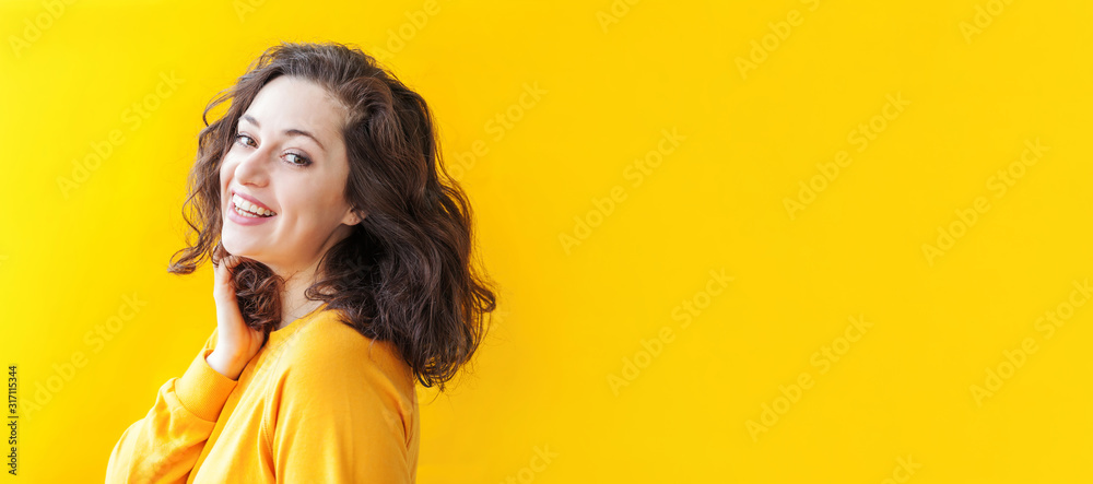 Happy girl smiling. Beauty portrait young happy positive laughing brunette woman on yellow background isolated. European woman. Positive human emotion facial expression body language