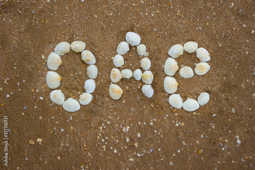 Inscription on sand from shells - uae, oae, camping, tourism © alexey_m