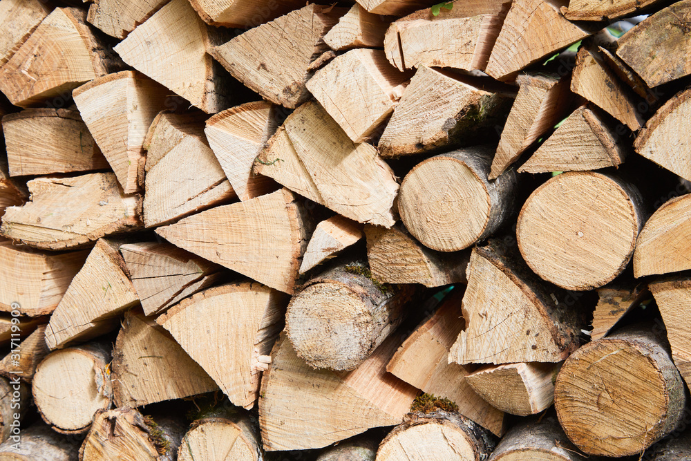 Stacks of firewood in the sawmill. Pile of firewood. Firewood background Stacks of firewood in the sawmill. Pile of firewood. Firewood background