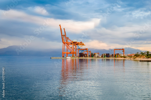 Loading cranes and stacked cargo containers at harbor in Rijeka, Croatia photo