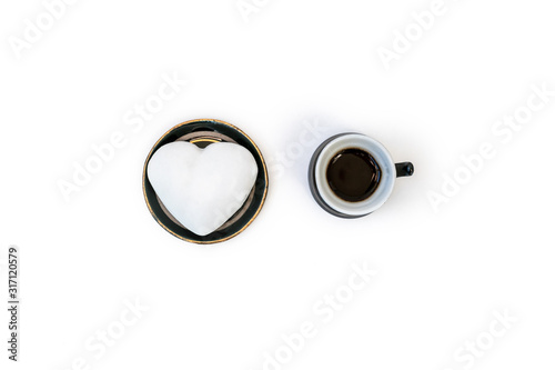 Valentine's Day minimal still life with cup of coffee, and plate with heart shaped ginger cookie on white background. Valentines Day celebration concept