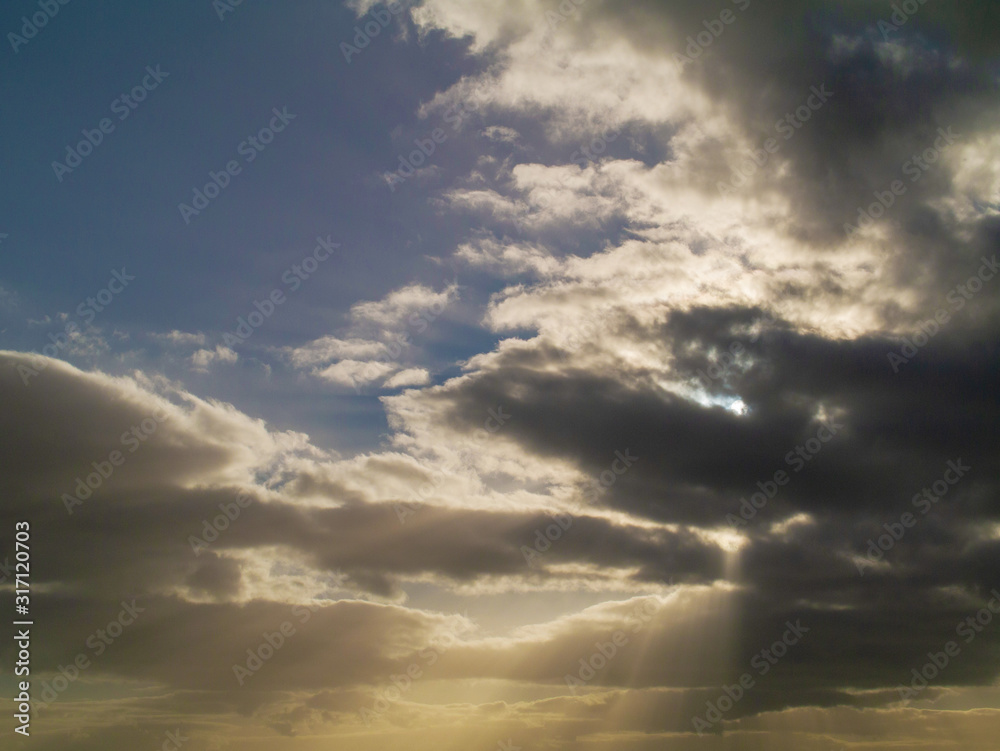 Obraz premium Blue dramatic sky with clouds, Abstract nature background. Sun rays.