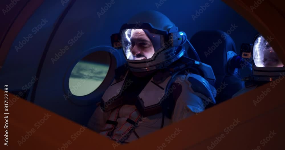 Male and female astronauts navigating spaceship Male and female astronauts navigating spaceship