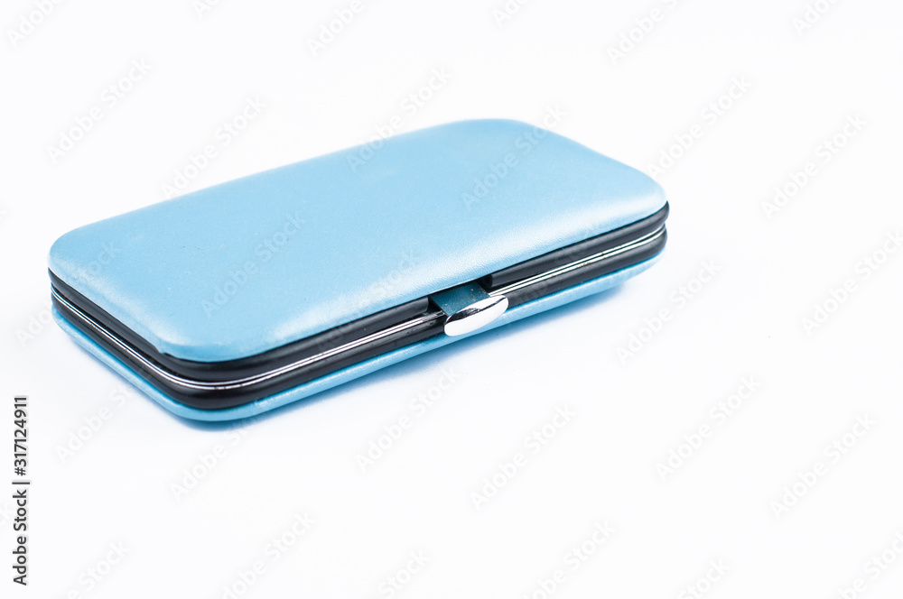  Set of tools for manicure in blue box isolated on white background. Copy space.