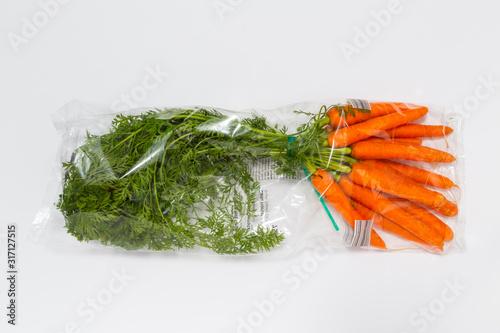 Use less plastic! Food in plastic packaging isolated on white ground. Symbol for environmental pollution done by the food industry