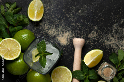 process of making homemade cocktail, flat with the ingredients for mojito on a black background, a refreshing summer cocktail