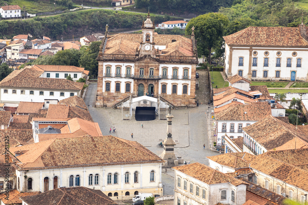 Central square of colonial mining city centre Ouro Preto in Minas Gerais, Brazil, with facade of the Museum of Inconfidence and Tiradentes monument seen from a high altitude and large distance
