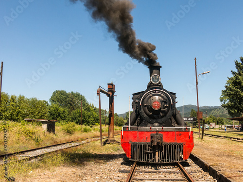 Tourist train called Valdiviano that runs from Valdivia to Antilhue with a 1913 North British locomotive type 57. Los Rios Region, in southern Chile. photo