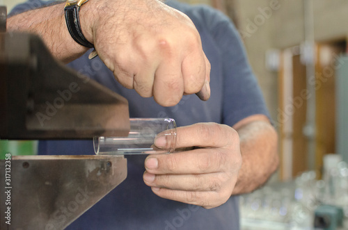  Working hands of handmade blown glass