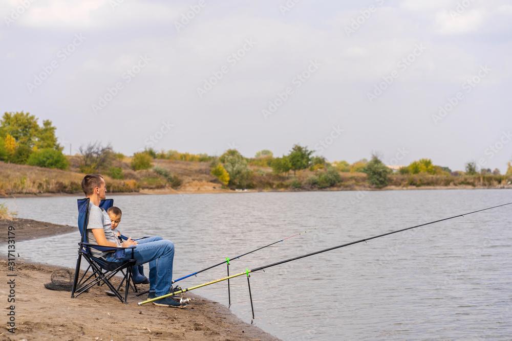 A happy family spends time together they teach their son to fish.