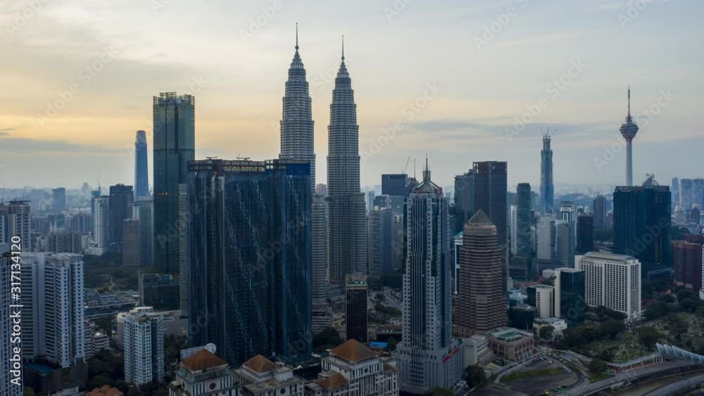 Kuala Lumpur, Malaysia - December 28, 2019: 4k establishing b-roll cinematic shot of hyperlapse drone panning view of sunrise at Kuala Lumpur city skyline. 