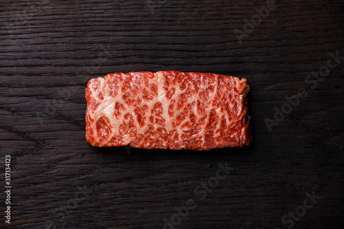 Raw fresh marbled meat Steak Wagyu beef on dark background photo