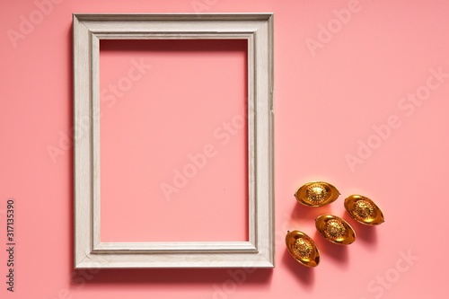 Chinese New Year concept with frame and ingots