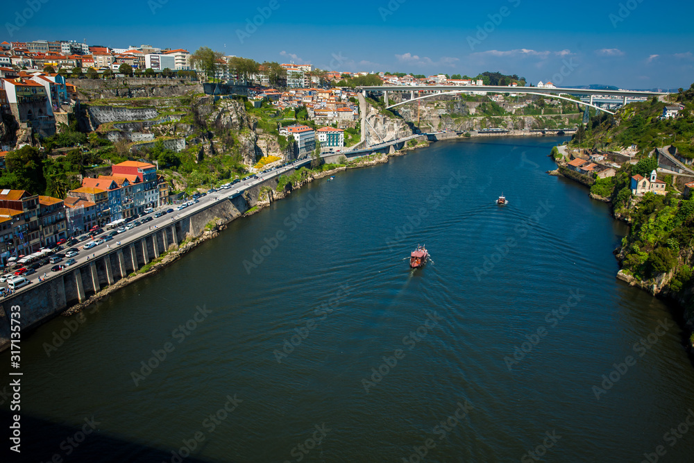 Boats sailing on the Douro River in a beautiful early spring day
