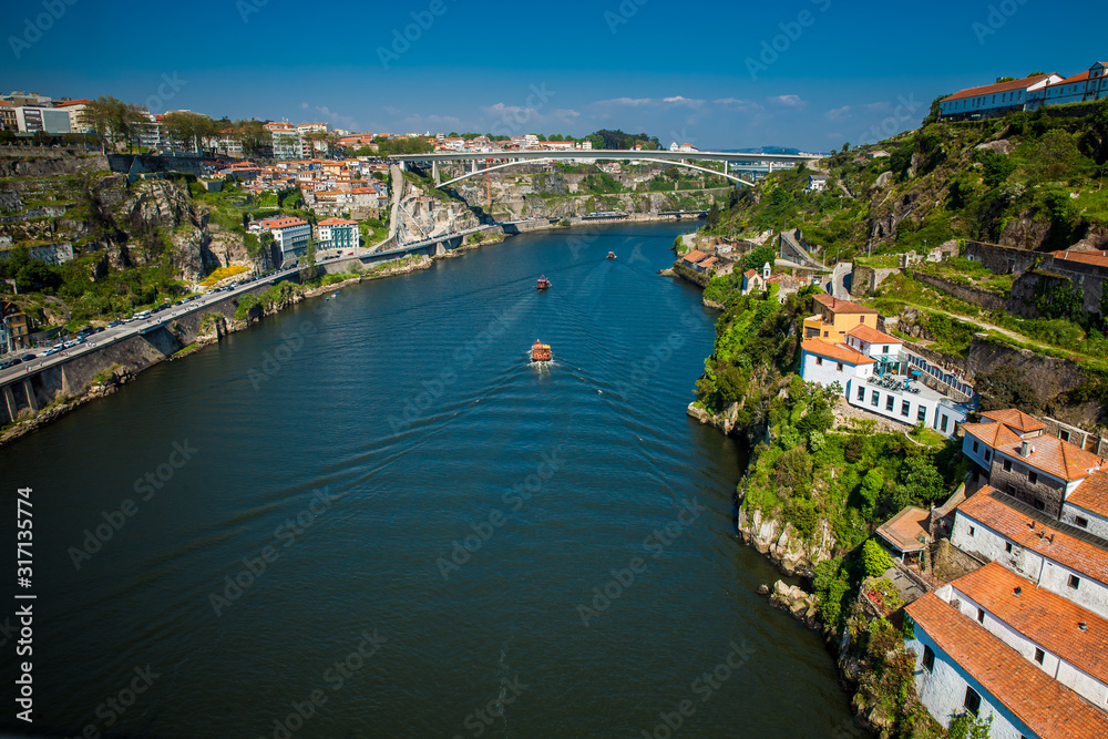 Boats sailing on the Douro River in a beautiful early spring day