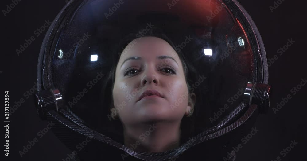 Portrait 4K Shot Of The Young Smiling Female Astronaut In Space Helmet. She Is Exploring Outer Space In A Space Suit. Science And Technology Related 4K Concept Footage.