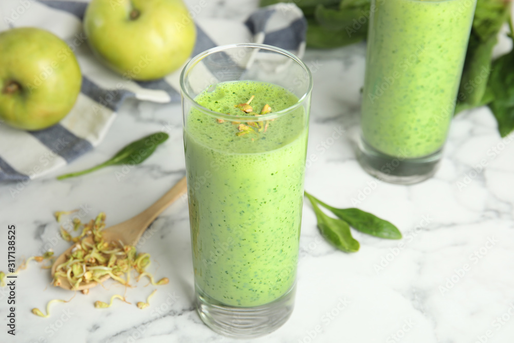 Green buckwheat smoothie on white marble table Green buckwheat smoothie on white marble table
