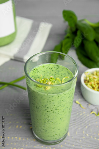 Green buckwheat smoothie on light grey wooden table