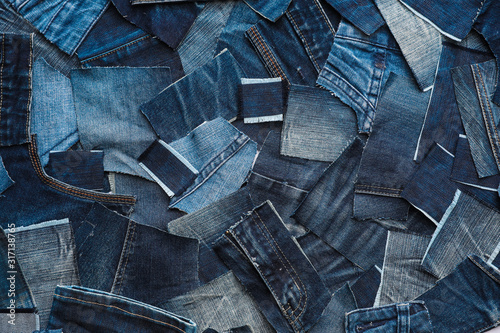 Many patches of old jeans as background, top view photo