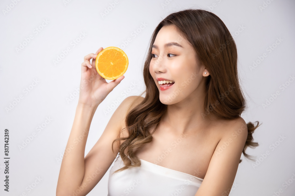 Beautiful Young Asian Woman short hair with Clean Fresh Skin. Face care, Facial treatment, Cosmetology, beauty and healthy skin and cosmetic ideas concept.pretty woman holding half of orange . Beautiful Young Asian Woman short hair with Clean Fresh Skin. Face care, Facial treatment, Cosmetology, beauty and healthy skin and cosmetic ideas concept.pretty woman holding half of orange .