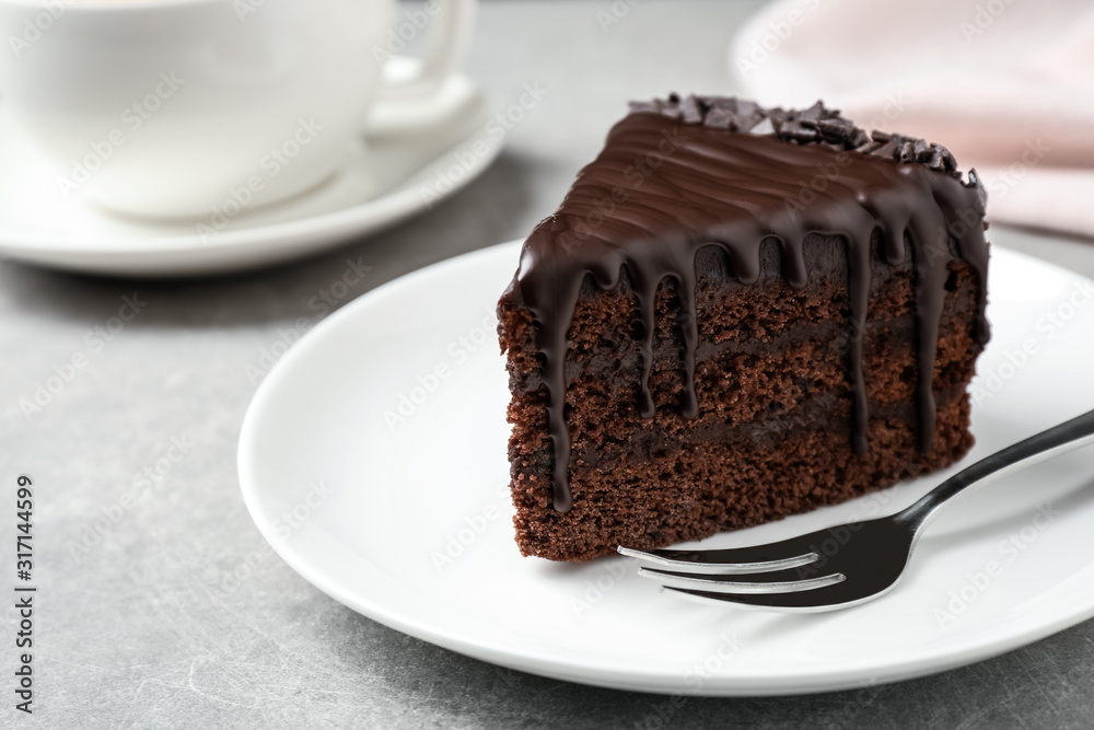 Delicious chocolate cake on light grey table, closeup Delicious chocolate cake on light grey table, closeup