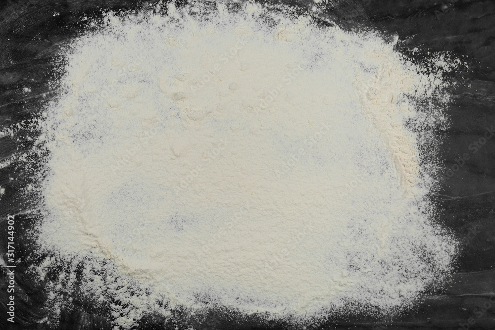 Flour on grey marble table, top view. Space for text Flour on grey marble table, top view. Space for text