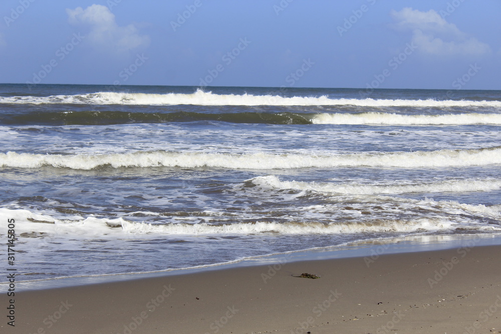 waves on the shore of the  Beach, blue sky