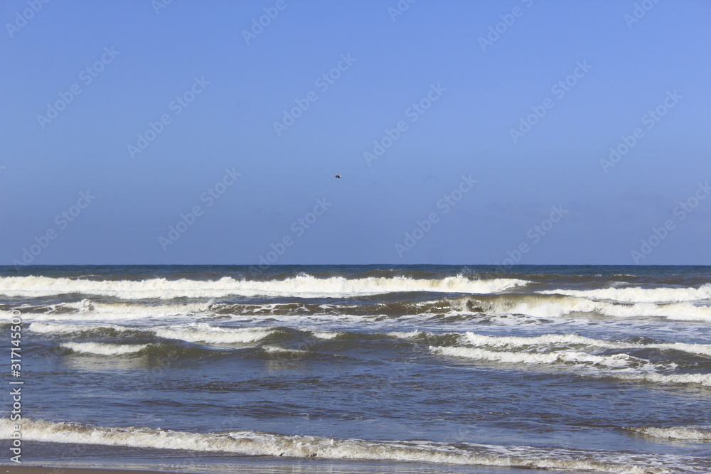 waves on the shore of the  Beach, blue sky