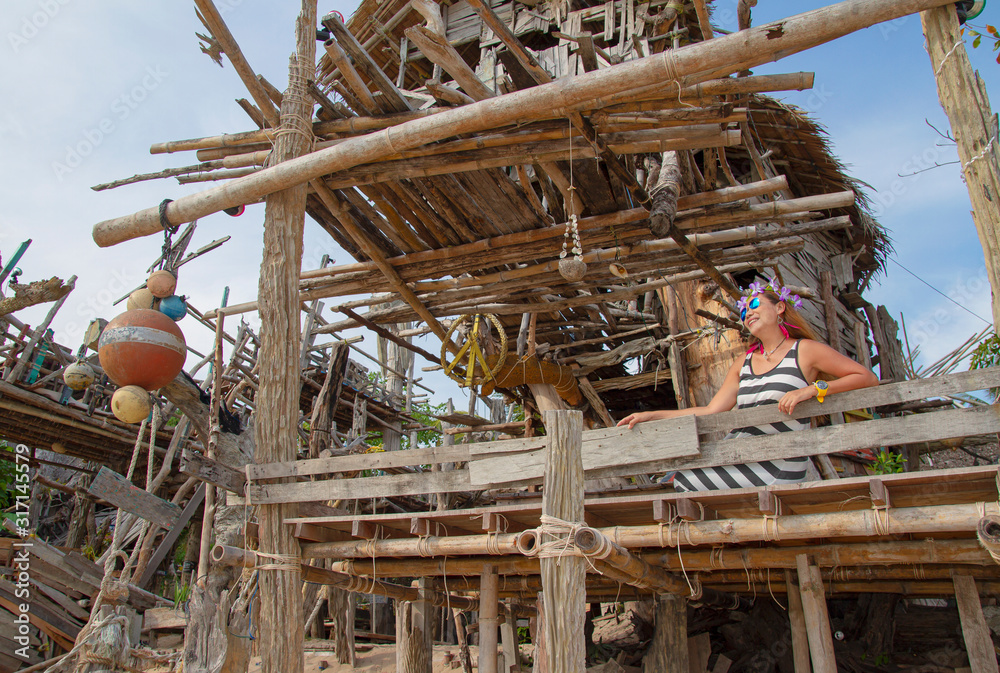 Thai girls relax and have fun, wood house backdrop on the beach, Ko Phayam, Thailand Thai girls relax and have fun, wood house backdrop on the beach, Ko Phayam, Thailand