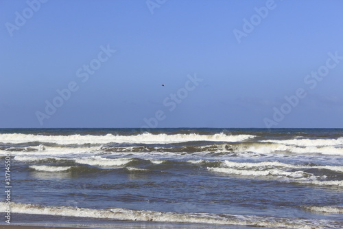 waves on the shore of the Beach, blue sky