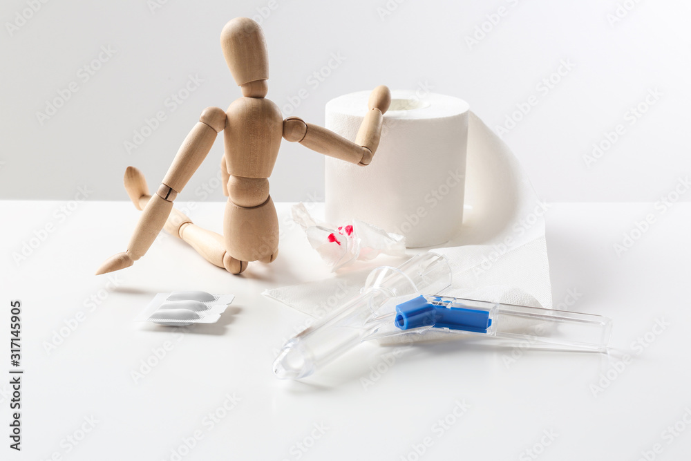 Composition with anoscope on white background. Hemorrhoid treatment