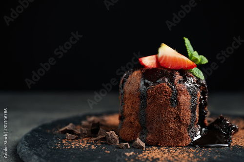 Canvas Print Delicious warm chocolate lava cake on slate board, closeup