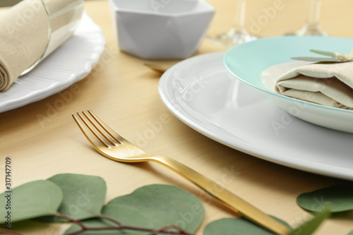 Elegant table setting with with golden cutlery, closeup