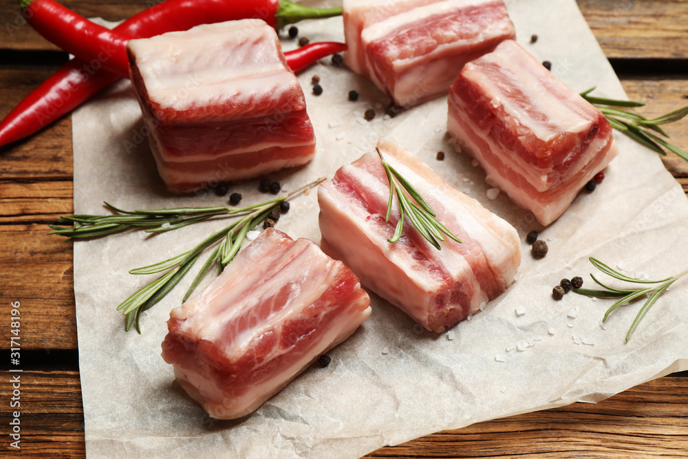 Raw ribs with rosemary on wooden table Raw ribs with rosemary on wooden table