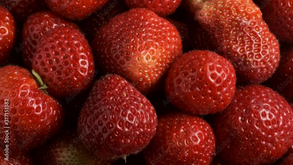 Slow motion rotation of juicy strawberries. Top view, Rotation 360 degrees, Extreme close up. Slow motion rotation of juicy strawberries. Top view, Rotation 360 degrees, Extreme close up.
