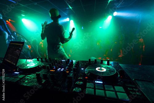 artist with a microphone performs on the stage of a nightclub