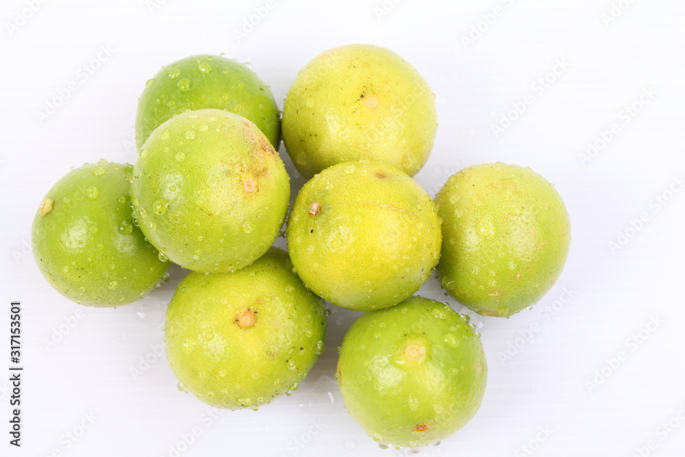 Fresh lime with water drops Isolated on white Fresh lime with water drops Isolated on white