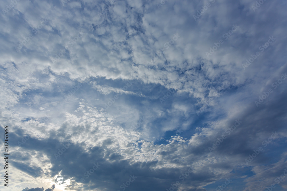 fallstreak hole cloud on dramatic blue sky