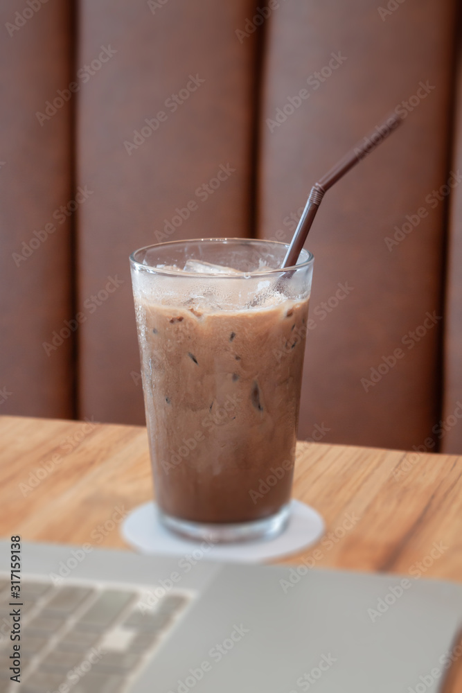 Iced coffee in coffee shop on wooden table Iced coffee in coffee shop on wooden table