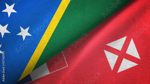 Solomon Islands and Wallis and Futuna two flags textile cloth, fabric texture photo