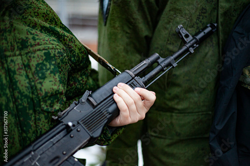 The barrel of an assault rifle. The weapon in the hands. Firearms in combat condition. Kalashnikov assault rifle. Training soldiers. Military subjects. For lovers of military training. 
