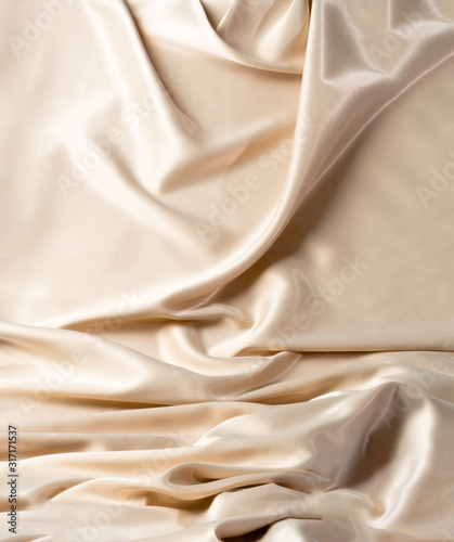 Abstract white wavy textile silk background with milky, creamy, champagne color