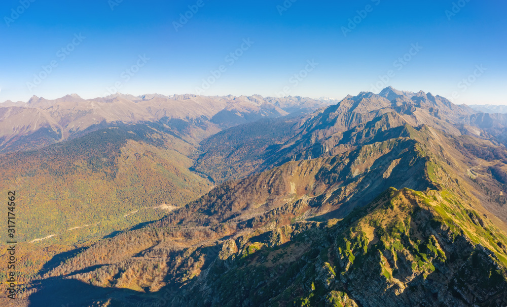Bird's-eye view of a mountain range and slopes with a mountain valley.
