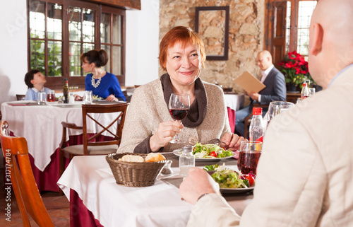 Mature woman with son in restaurant