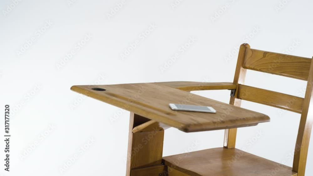 A school desk with a smart phone on it with white background A school desk with a smart phone on it with white background